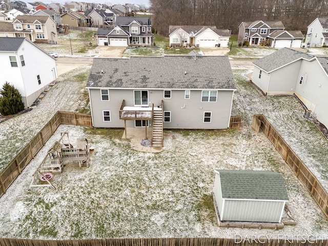 rear view of property with a deck, a residential view, a fenced backyard, and stairway