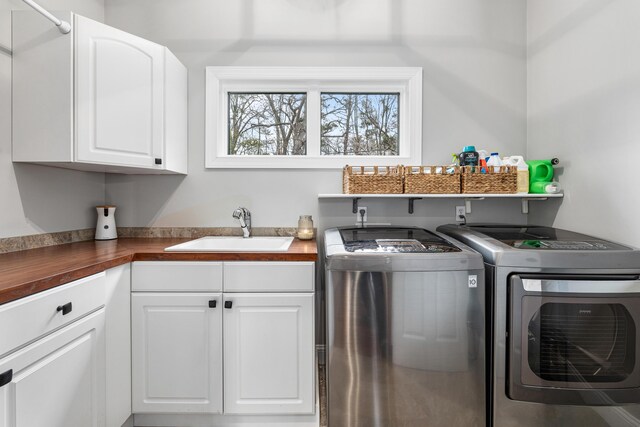 14788 Boom Rd, Spring Lake, MI 49456 - clothes washing area with cabinet space, a sink, and washing machine and clothes dryer