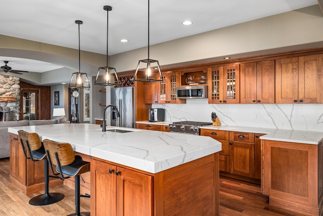 14788 Boom Rd, Spring Lake, MI 49456 - kitchen with open floor plan, a ceiling fan, high quality appliances, and brown cabinets