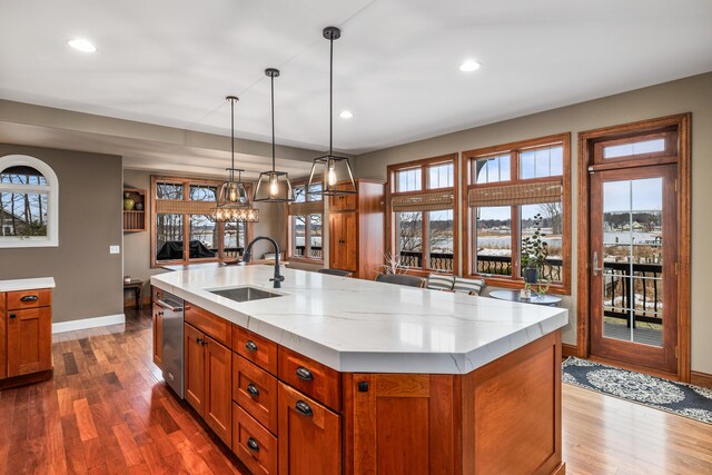 14788 Boom Rd, Spring Lake, MI 49456 - kitchen with brown cabinetry, dark wood finished floors, a wealth of natural light, and a sink
