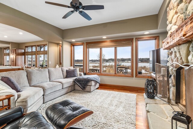14788 Boom Rd, Spring Lake, MI 49456 - living area featuring ceiling fan, a stone fireplace, light wood-style flooring, and recessed lighting
