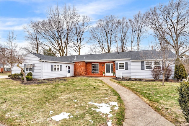 single story home with a front lawn and brick siding