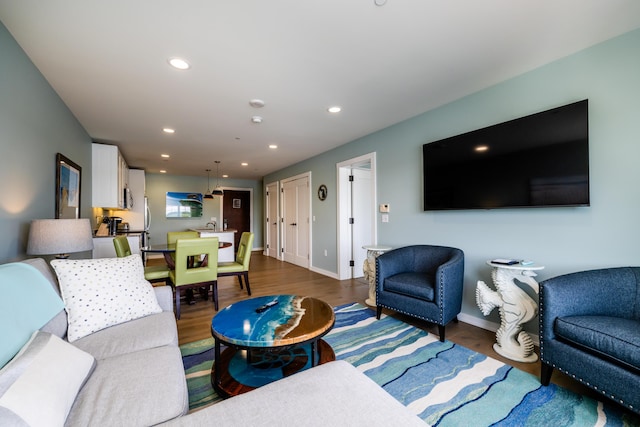 living room featuring baseboards, dark wood-style flooring, and recessed lighting