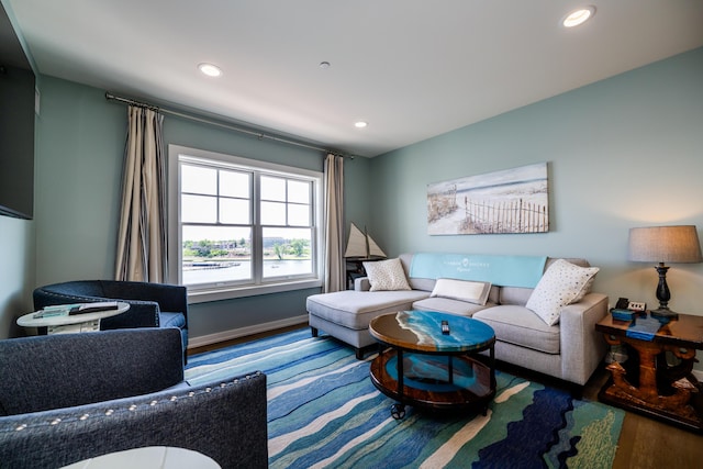 sitting room with baseboards, wood finished floors, and recessed lighting