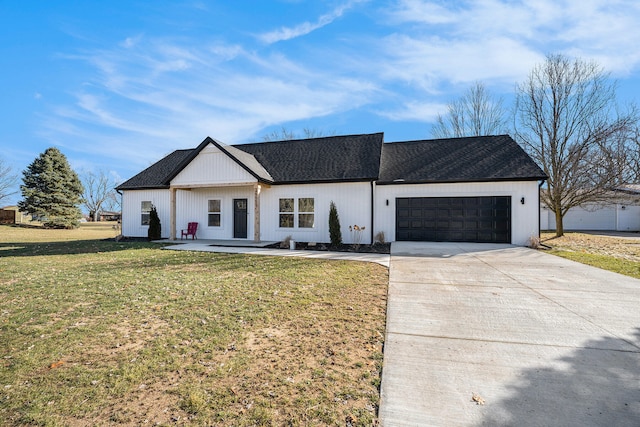 modern inspired farmhouse with a garage, driveway, a shingled roof, and a front yard