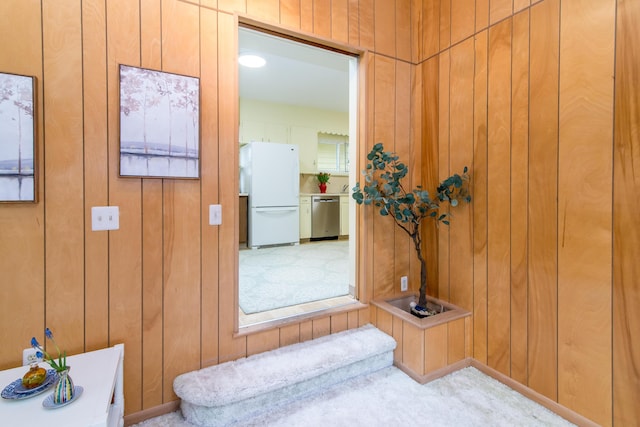 hallway with stairway, carpet floors, and wooden walls