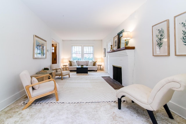 living room featuring a fireplace and baseboards