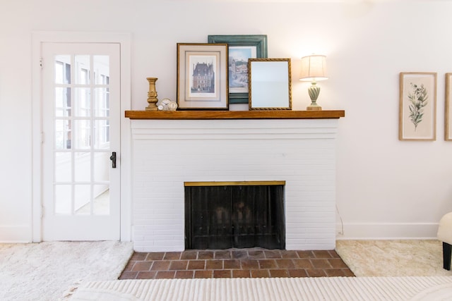 interior details with a brick fireplace