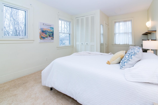 bedroom featuring a closet, carpet flooring, and baseboards