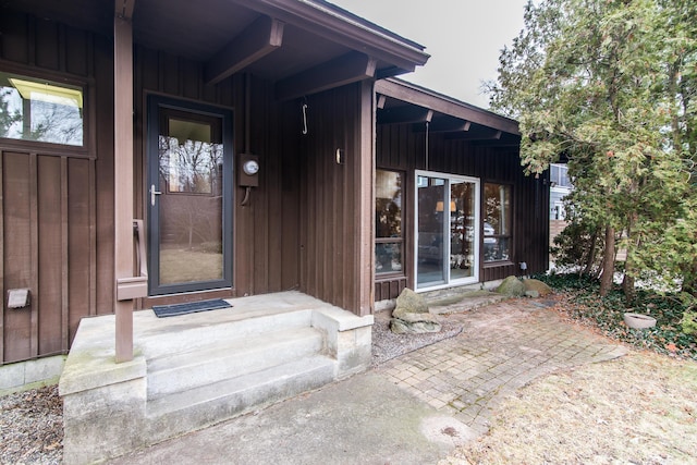 view of exterior entry with board and batten siding