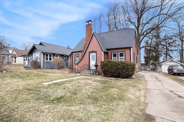 view of front of house featuring a front lawn, a chimney, an outdoor structure, and a shingled roof