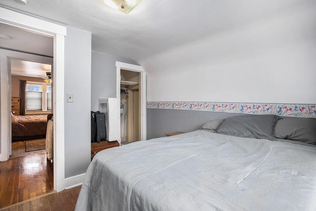 bedroom featuring baseboards and hardwood / wood-style floors