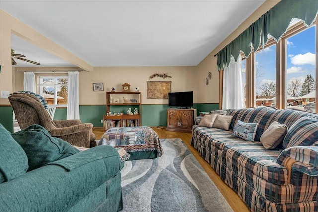 living room with a wainscoted wall and wood finished floors