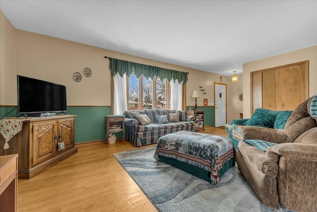 living area with light wood finished floors and baseboards