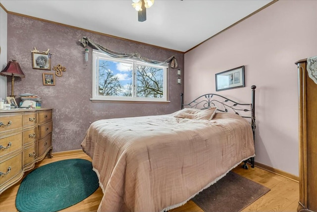 bedroom with a ceiling fan, light wood-style flooring, and baseboards