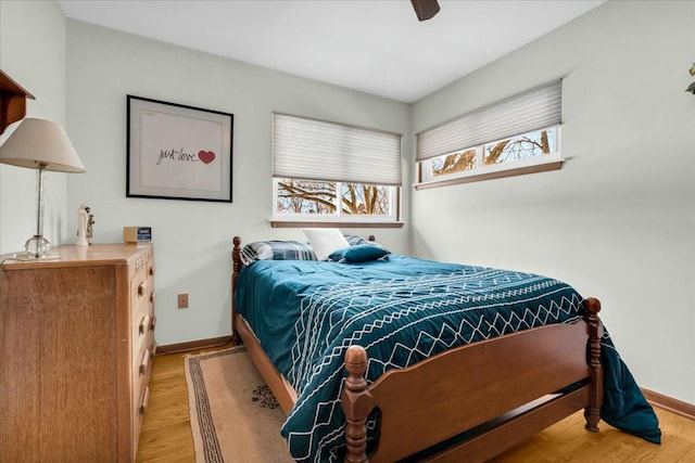 bedroom with baseboards, ceiling fan, and light wood finished floors