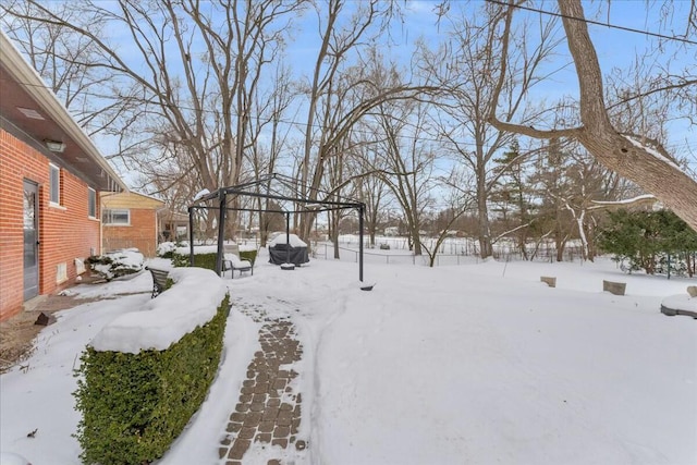 snowy yard featuring a gazebo