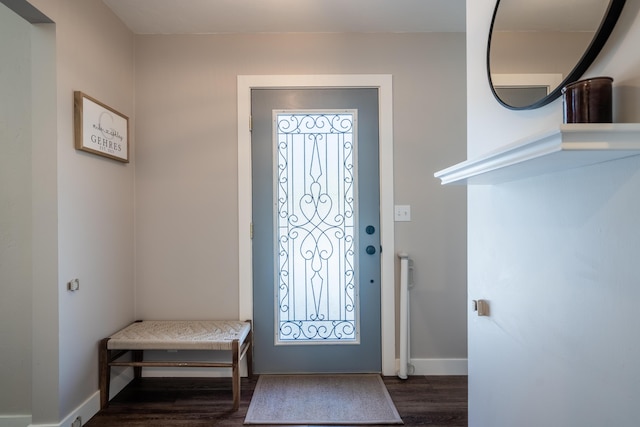 entryway with dark wood-type flooring and baseboards