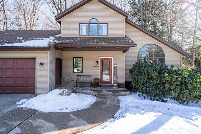 chalet / cabin featuring a garage and covered porch