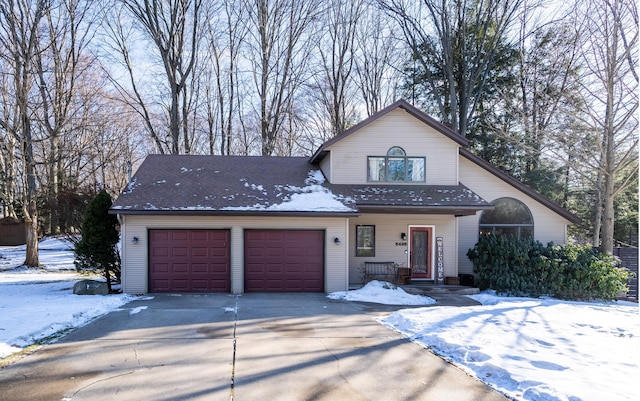 view of front of property featuring concrete driveway and an attached garage