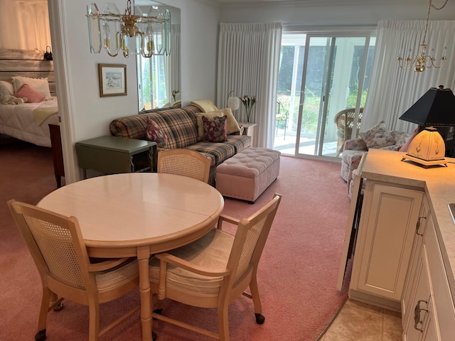 dining space featuring an inviting chandelier, light tile patterned floors, and light colored carpet