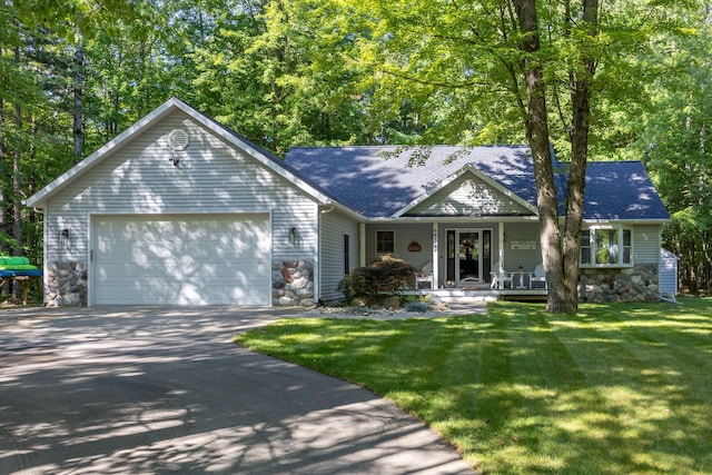 ranch-style house with a porch, a front yard, a garage, stone siding, and driveway