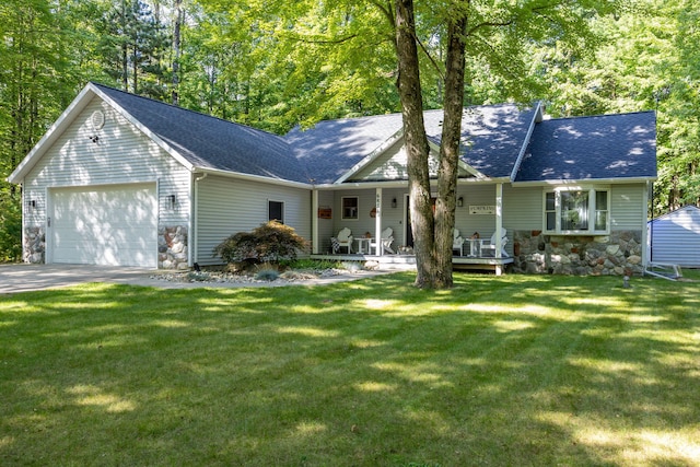 ranch-style house featuring stone siding, a shingled roof, an attached garage, and a front yard