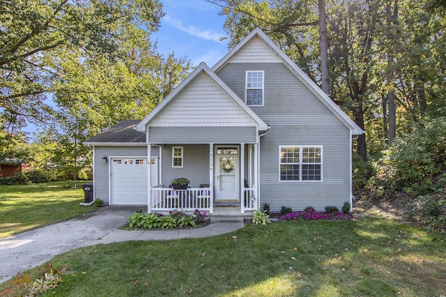 view of front of house with a garage, driveway, a front lawn, and a porch