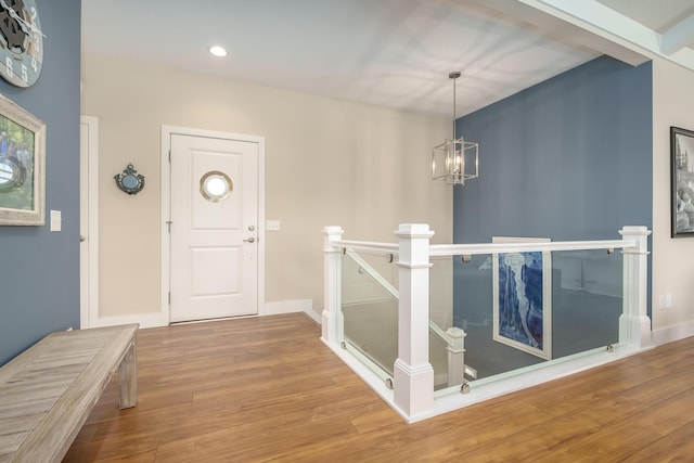 entryway featuring baseboards, recessed lighting, wood finished floors, and a notable chandelier