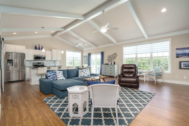 living area with lofted ceiling with beams, ceiling fan, recessed lighting, dark wood-style flooring, and baseboards