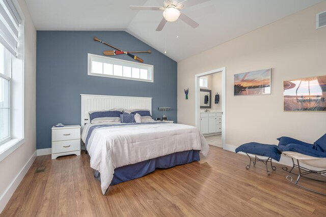bedroom featuring visible vents, vaulted ceiling, baseboards, and wood finished floors