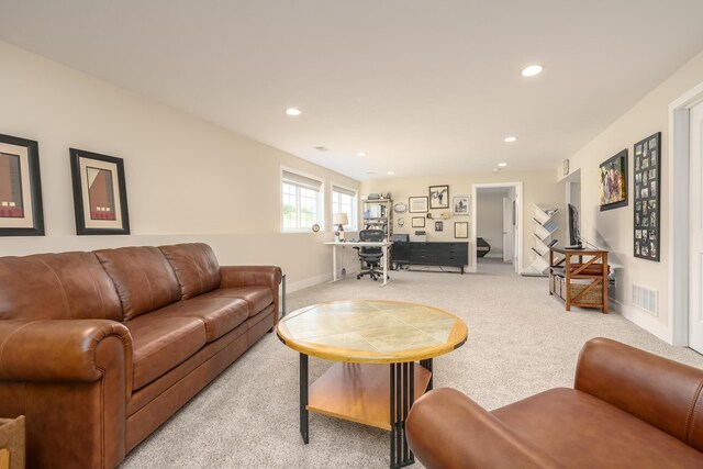 living room featuring baseboards, recessed lighting, visible vents, and light colored carpet