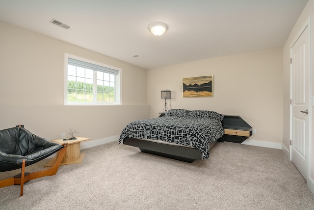 bedroom with baseboards, visible vents, and carpet flooring