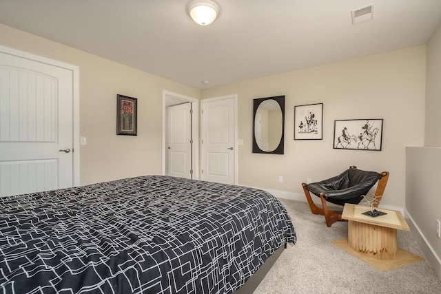 carpeted bedroom featuring visible vents and baseboards