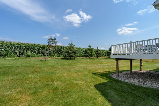 view of yard with a rural view and a wooden deck