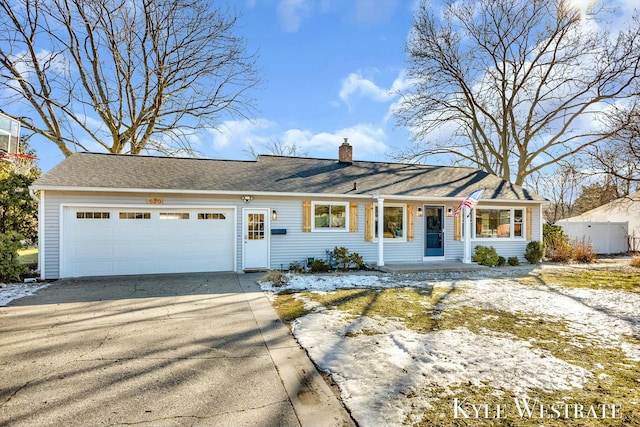 single story home featuring driveway, a garage, and a chimney