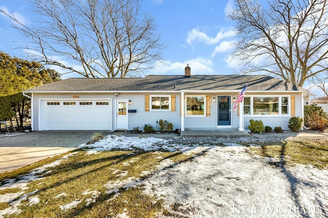 ranch-style home featuring driveway, an attached garage, and a chimney