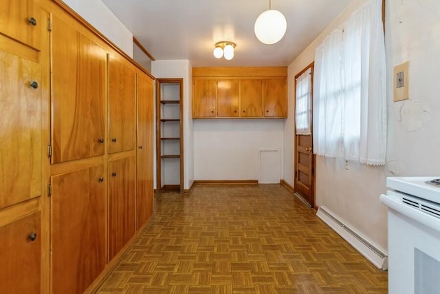 hallway featuring a baseboard radiator and baseboards