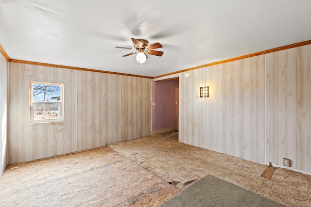 unfurnished room with a ceiling fan and crown molding