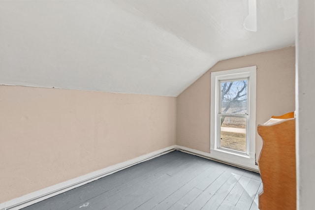 bonus room with lofted ceiling and wood finished floors