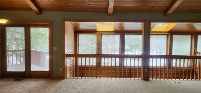 unfurnished sunroom with visible vents, beamed ceiling, and wood ceiling