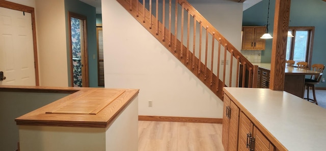 interior space featuring baseboards and wood finished floors