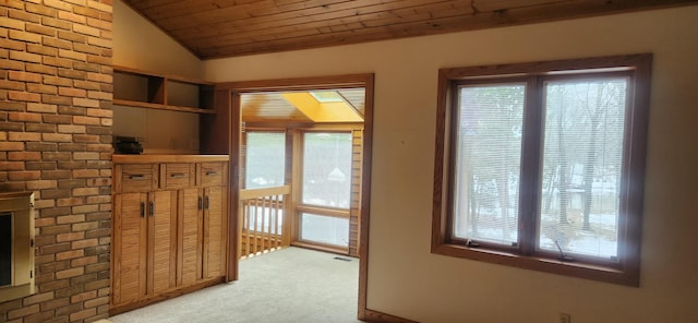 interior space with lofted ceiling, plenty of natural light, wooden ceiling, and light colored carpet