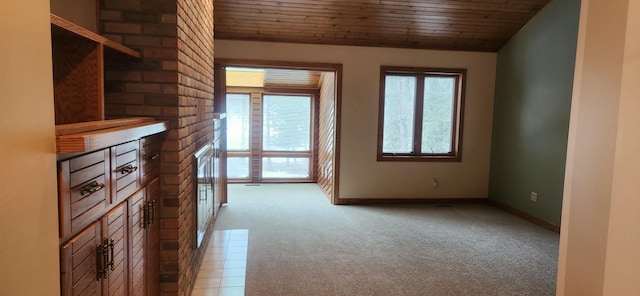 interior space featuring lofted ceiling, wooden ceiling, light colored carpet, and baseboards