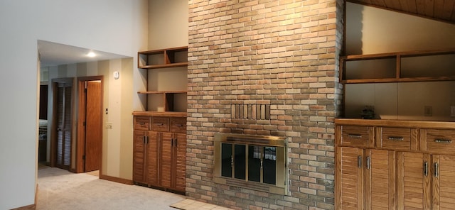 unfurnished living room featuring lofted ceiling, carpet, a fireplace, and baseboards