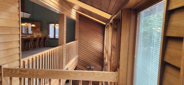 interior space with wood ceiling and wooden walls