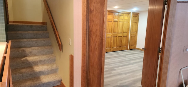 staircase with wood finished floors and baseboards