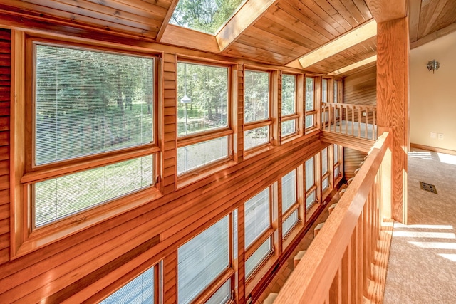 3075 Mineral Springs Trl, Mount Pleasant, MI 48858 - detailed view of carpet flooring, a wooden ceiling with exposed beams, and a skylight
