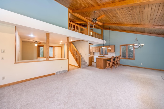 3075 Mineral Springs Trl, Mount Pleasant, MI 48858 - living area featuring a ceiling fan, a wood ceiling with exposed beams, light carpet, stairs, and high vaulted ceiling