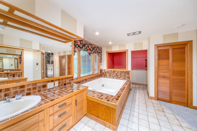 3075 Mineral Springs Trl, Mount Pleasant, MI 48858 - bathroom with a closet, a jetted tub, vanity, tile patterned floors, and recessed lighting
